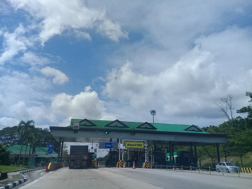A Malaysian expressway toll plaza with Touch 'n Go payment lanes
